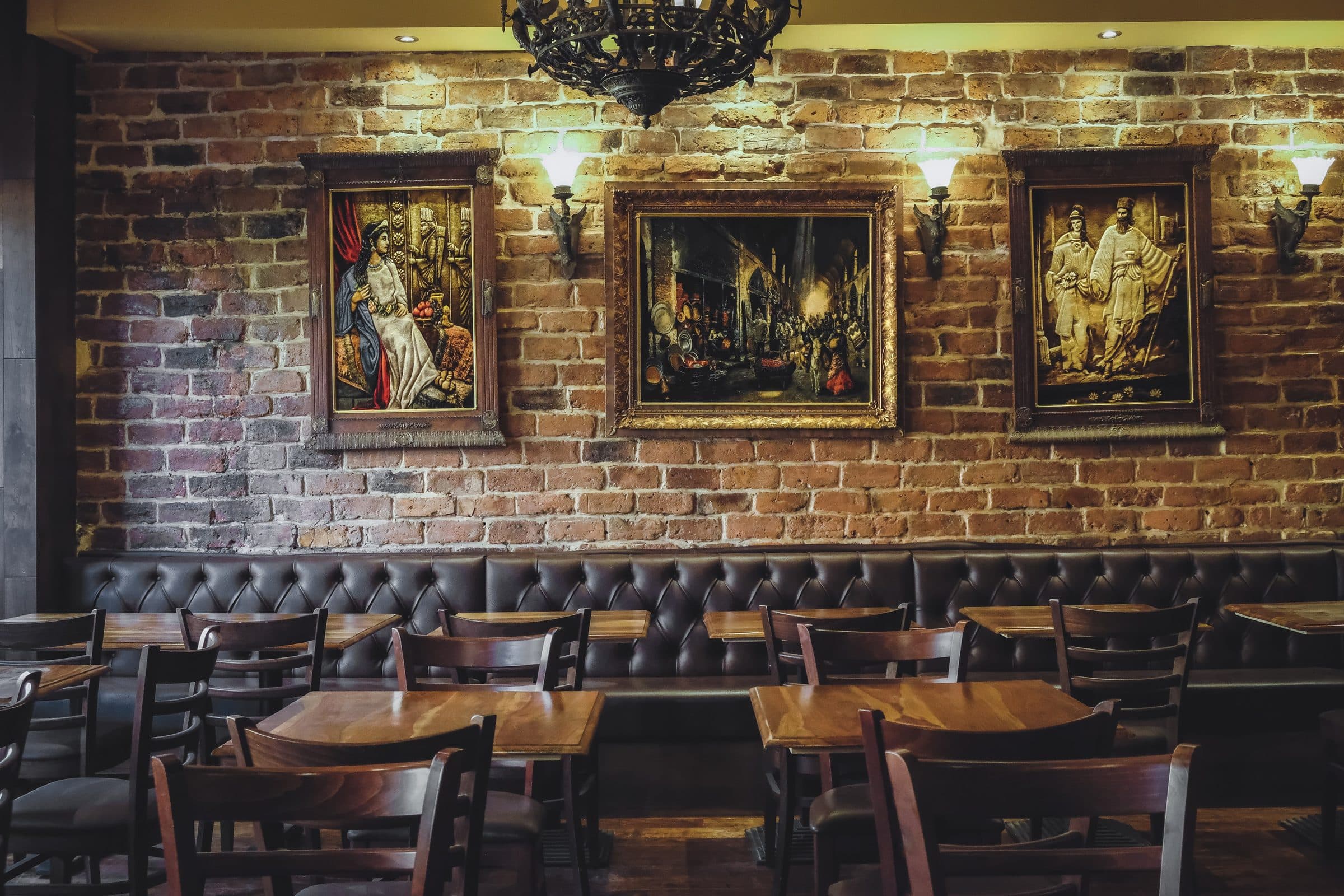 Inside Saffron — exposed brick, leather banquettes and framed Persian art under warm lamplight